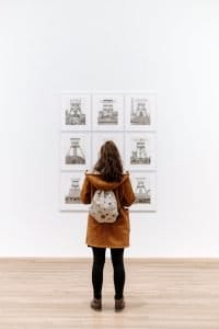 Woman in a museum inspecting a painting