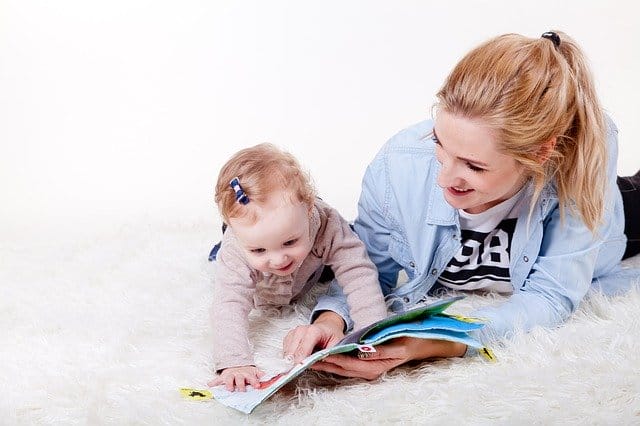 Mom reading to her baby girl