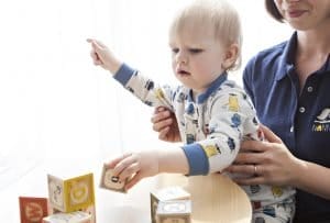 a baby playing with cubes