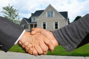 a handshake in front of the house