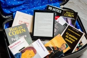 Books and a tablet in a suitcase - eco-friendly packing supplies