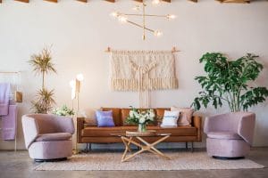 a leather sofa and two pink armchairs