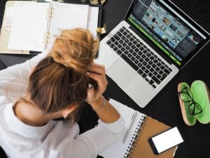 A girl stressing out about something on her laptop