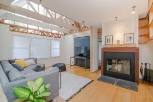 a fireplace and a grey sofa