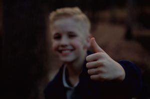 Young boy showing thumb up