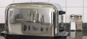 a gray toaster on the kitchen counter as one of many appliances that require professional handling