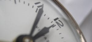 a white clock showing 5 to 12
