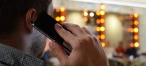 a person talking on the phone in their living room