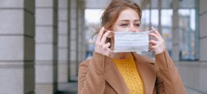 A woman putting o a mask.