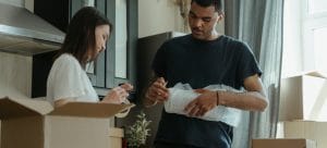 a couple packing items together in their kitchen