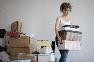a woman holding boxes