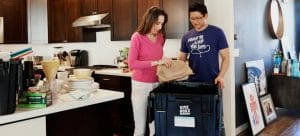 a couple preparing their kitchen for the packing process