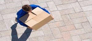 man carrying cardboard box 