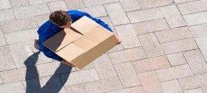 man carrying cardboard box