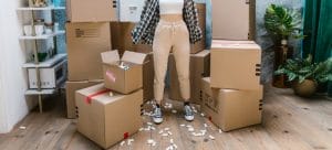 girl standing with packed boxes