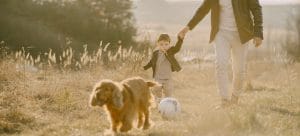 child and parent with dog