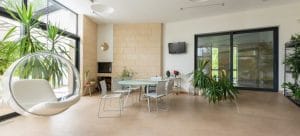 Inside of the spacious room with whte table and plants