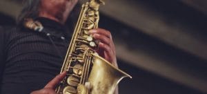 a person playing a gold saxophone on the local music scene in las vegas