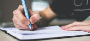 a man writing down a plan using unpacking tips for moving to Las Vegas