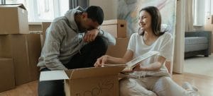 People unpacking a moving box after moving from Las Vegas to Los Angeles