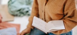 A woman holding a notebook