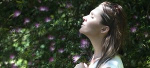 Picture of a relaxed woman who is thinking about mindful moving tips for a more peaceful long distance transition